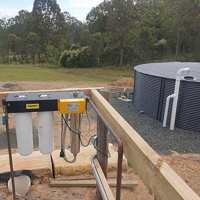 rainwater tanks connected to gutters on shed